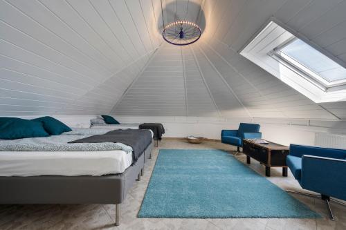 a attic bedroom with two beds and a clock on the ceiling at Bella Ciao in Badacsonytomaj