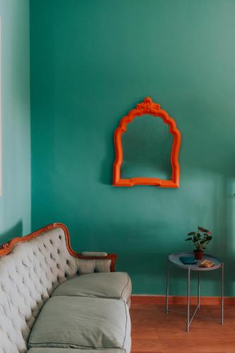 a couch in a room with a green wall at Habari We Dorm in Bari