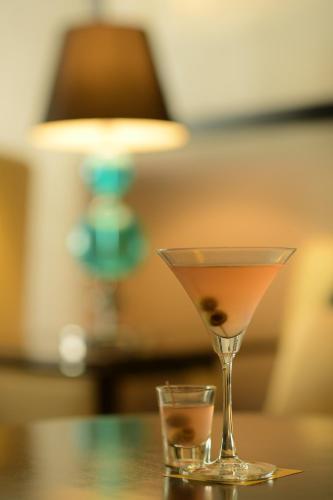 a martini glass sitting on a table with a drink at Radisson Blu Hotel Guwahati in Guwahati