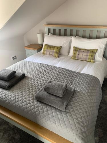 a bedroom with a bed with two towels on it at The Teviot in the centre of Melrose in Melrose