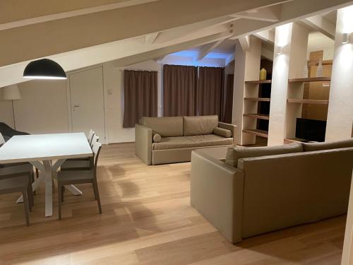 a living room with two couches and a table at Ceccarini Suite in Riccione