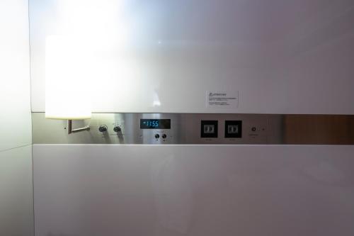 a light on top of a machine in a room at Torifito Hotel & Pod Kanazawa in Kanazawa