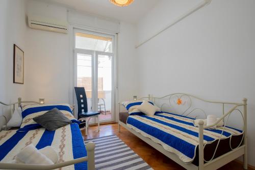 a bedroom with two beds and a window at Amphitheater Apartment in Pula