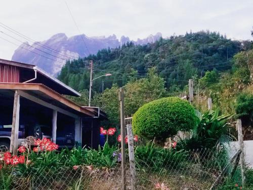 a house with a view of a mountain at Kinabalu Valley Guesthouse in Kundasang