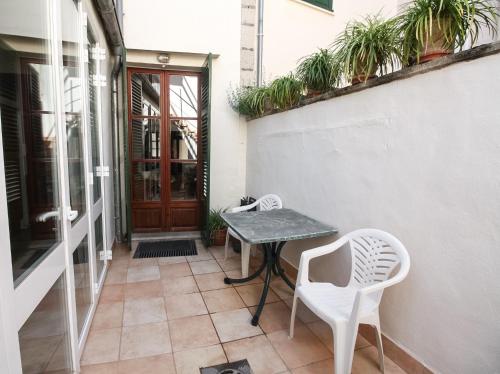 a small table and two chairs on a patio at Casa Carrer de Bonany in Sóller