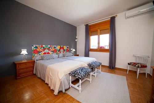 a bedroom with a large bed and a window at Casa Rural Cece 4estrellas in Puebla del Salvador