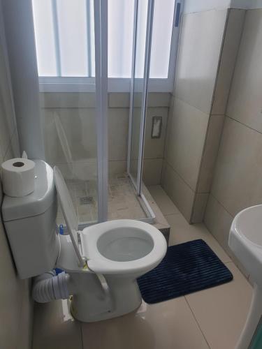 a small bathroom with a toilet and a sink at Modern Oxford Street Apartment - 40 CZ KUBS in East London