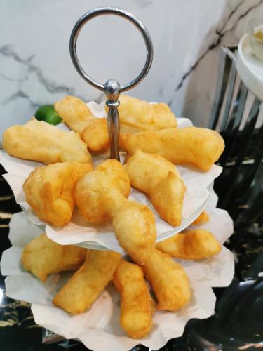 a pile of food on a plate with a keychain at Morakot Twin Chumphon in Chumphon