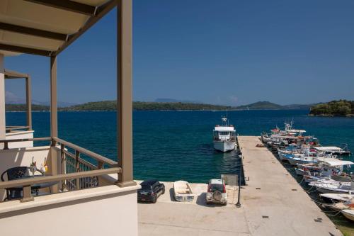 a group of boats are docked at a dock at Enalion top floor apartment with viewboat dock & close to Nidri! in Nydri