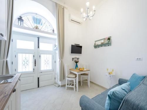 a living room with a blue couch and a table at Apartments Franka Old Town in Dubrovnik