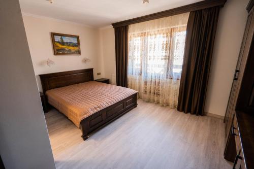 a bedroom with a bed and a large window at Готель-ресторан Каміла in Polyana