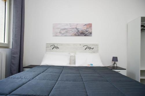 a bedroom with a large bed with a blue blanket at Il Caubbio in Lacona