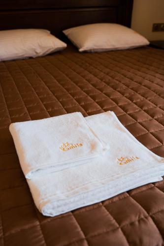 two towels sitting on top of a bed at Готель-ресторан Каміла in Polyana