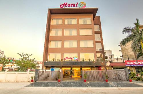 a tall building with a sign on top of it at Hotel 91 Huda City Centre in Gurgaon