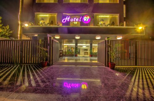 a building with neon signs on the front of it at Hotel 91 Huda City Centre in Gurgaon
