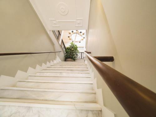 a staircase in a building with a potted plant at Filoxenia Hotel in Chios