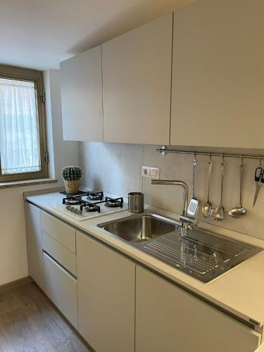 a kitchen with a sink and a stove at La Mansarda in Caserta