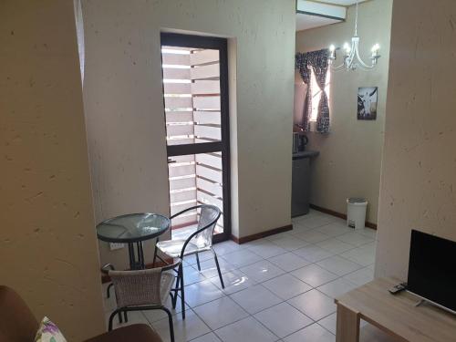 a room with a table and chairs and a window at Vaal de Grace River Village in Parys