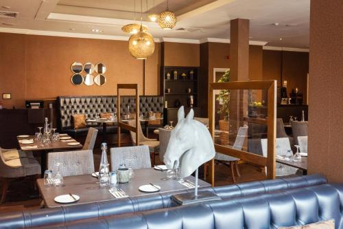 a restaurant with a table with a shark head on it at Mercure Milton Keynes Hotel in Milton Keynes
