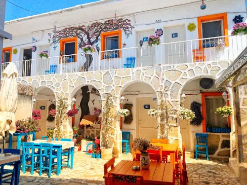 budynek z kolorowymi stołami i krzesłami przed nim w obiekcie Bodrum Sade Pension w Bodrum