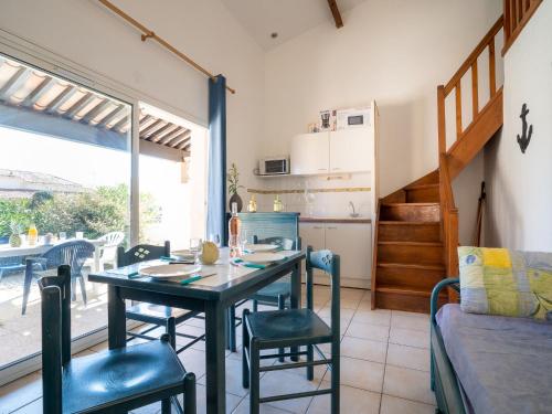 a kitchen and dining room with a table and chairs at Holiday Home Hacienda Beach II-4 by Interhome in Cap d'Agde