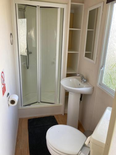 a bathroom with a shower and a toilet and a sink at Sandy Feet Retreat, reduced ferry fair, please contact us direct in Sandown