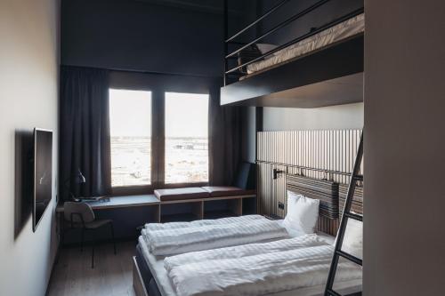 a bedroom with two bunk beds and a window at Comfort Hotel Arlanda Airport Terminal in Arlanda