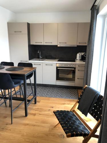 a kitchen with a table and chairs in a room at Ski & Nature Apartment in Mauterndorf
