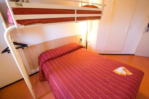 a bedroom with two bunk beds in a room at Premiere Classe Le Blanc Mesnil in Le Blanc-Mesnil