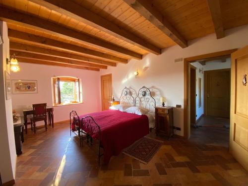 a bedroom with a bed and a table and chairs at All'Antica Scuderia Del Castello in Maiano