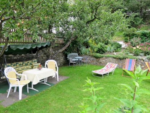 a group of chairs and a table in a yard at Holiday Home Palman by Interhome in Pfunds