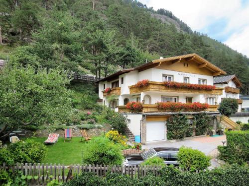 a house with a garden in front of a mountain at Holiday Home Palman - PFD160 by Interhome in Pfunds