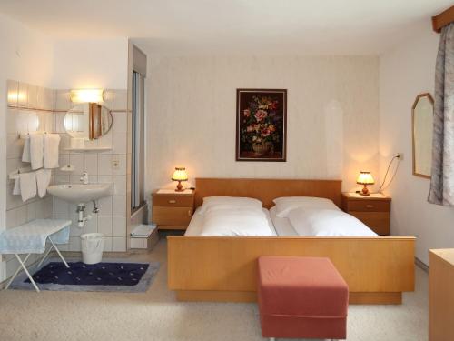 a bedroom with a bed and a sink and a bathroom at Holiday Home Palman by Interhome in Pfunds