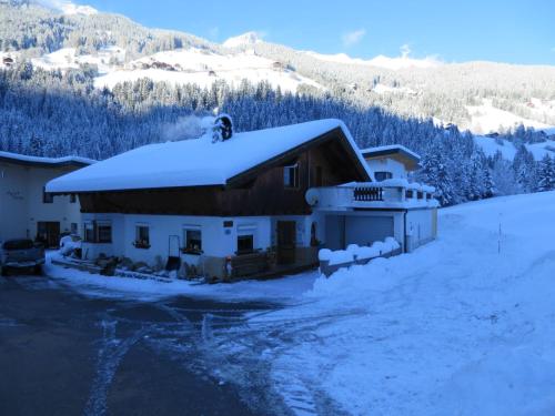 a house covered in snow in the mountains at Apartment Prem by Interhome in Kappl