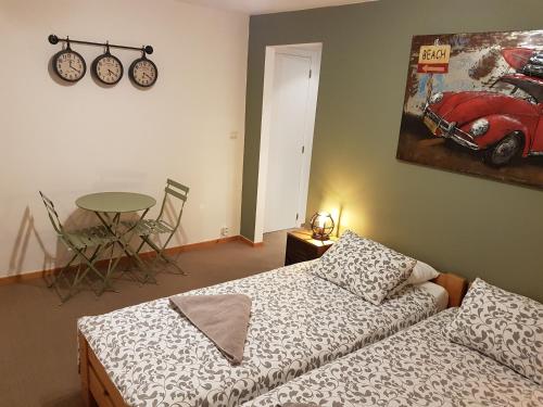 a bedroom with a bed and a table and a bike on the wall at B&B Brigitte & Alain in Brussels