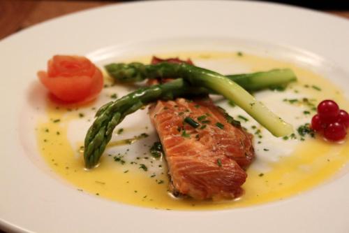 a plate of food with a piece of salmon and asparagus at Embleton Spa Hotel & Apartments in Embleton