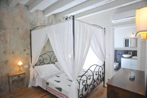 a bedroom with a bed with a canopy at Casa Lumaca in Tremezzo