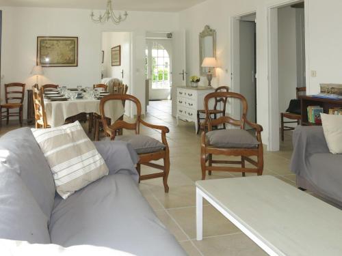 a living room with a couch and chairs and a table at Holiday Home Pen Er Guer - RHU362 by Interhome in Saint-Gildas-de-Rhuys