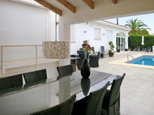 a dining room with a table and chairs and a pool at Holiday Home Ki - ATE248 by Interhome in La Nucía