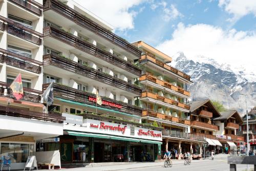 a large building with a mountain in the background at Hotel Bernerhof Grindelwald in Grindelwald