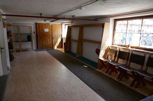an empty room with chairs and a window at Pension & Ferienwohnungen Haus Edelweiß in Holzgau