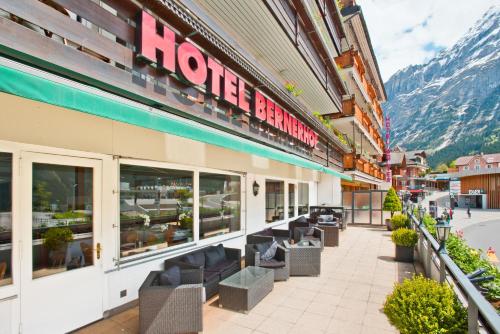a hotel with chairs in front of a building at Hotel Bernerhof Grindelwald in Grindelwald
