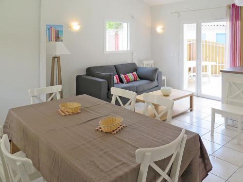 a living room with a table and a couch at Holiday Home Résidence Plage Océane - BPL343 by Interhome in Biscarrosse-Plage