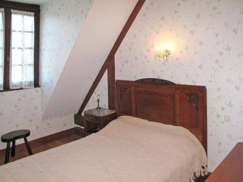 a bedroom with a bed and a chair in it at Holiday Home Marchives by Interhome in Pionnat