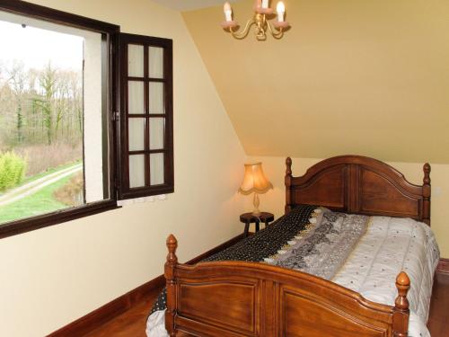 a bedroom with a bed and a window at Holiday Home Marchives by Interhome in Pionnat