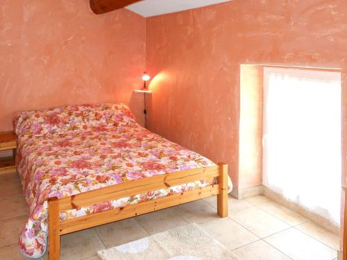 a bedroom with a bed in a room with a window at Holiday Home La Cardeline by Interhome in Grillon