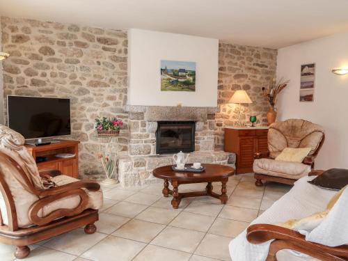 un salon avec un mur en pierre dans l'établissement Holiday Home Ty Breiz by Interhome, à Ploemeur