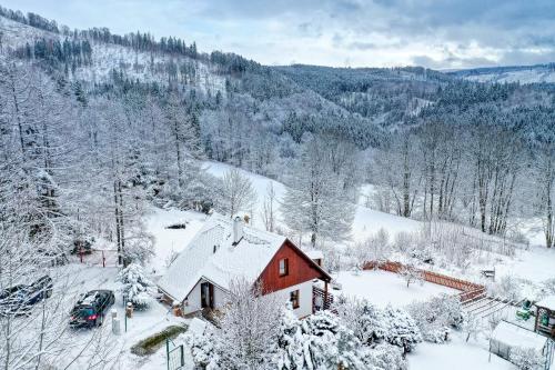a small red house with snow on it at CHALUPA NA VYHLÍDCE in Jeseník