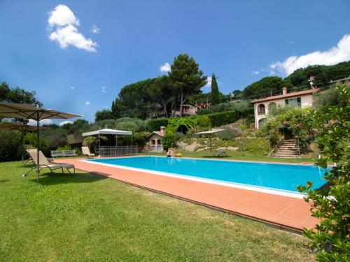 a swimming pool in the yard of a house at Villa Olindia by Interhome in San Savino