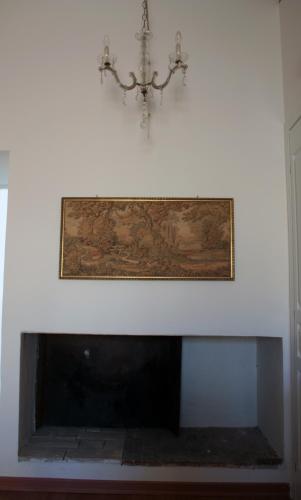 a painting on a wall above a fireplace at Affittacamere Arco Polinori in Foligno